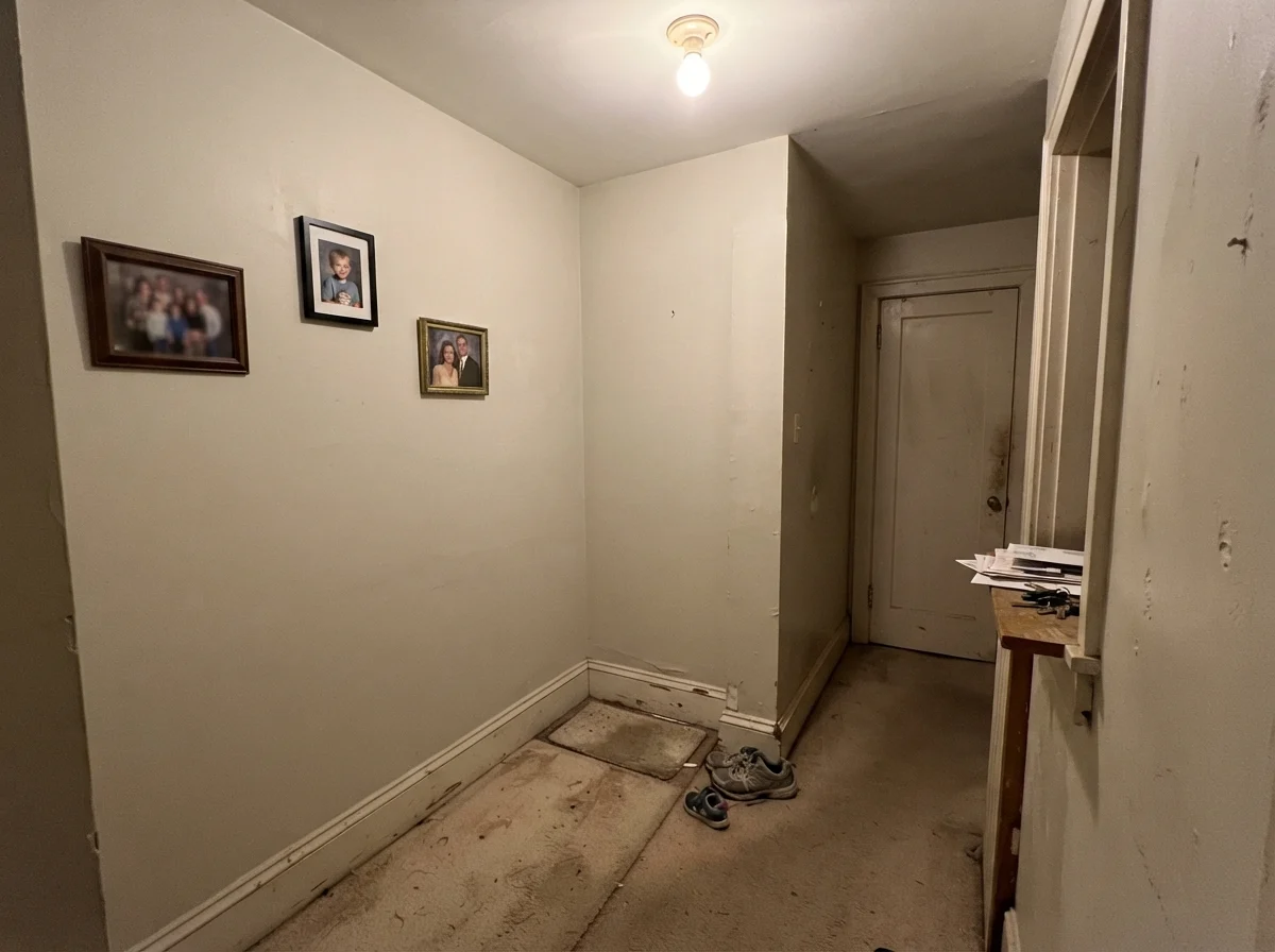 Dim windowless hallway showing Dove Wing paint looking muddy and gray under poor lighting.