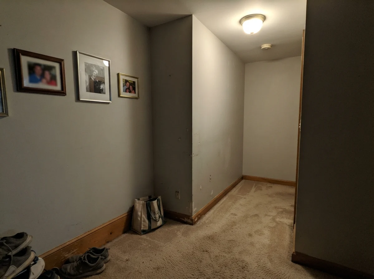 Dim windowless hallway showing Gray Owl looking muddy and flat under artificial light.