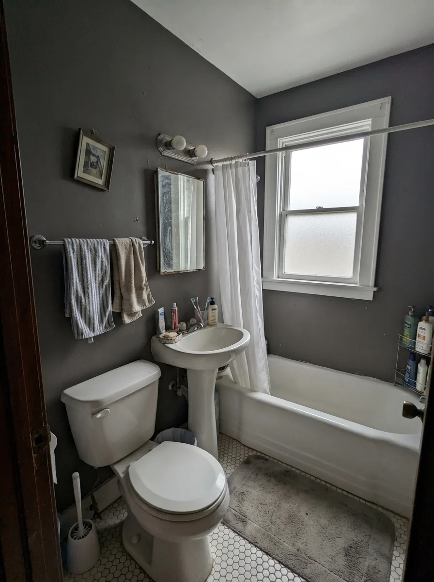 Small bathroom painted Kendall Charcoal under flat overcast daylight with white fixtures.