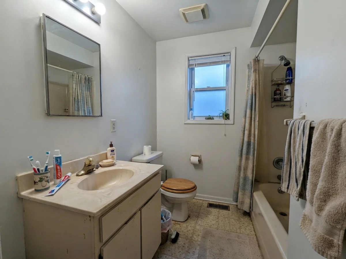 Dated bathroom showing White Dove taking on a cool cast from north window light