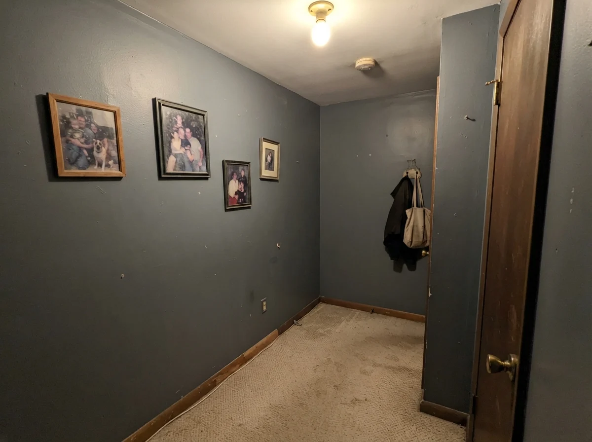 Dim windowless hallway where the paint looks flat and muddy