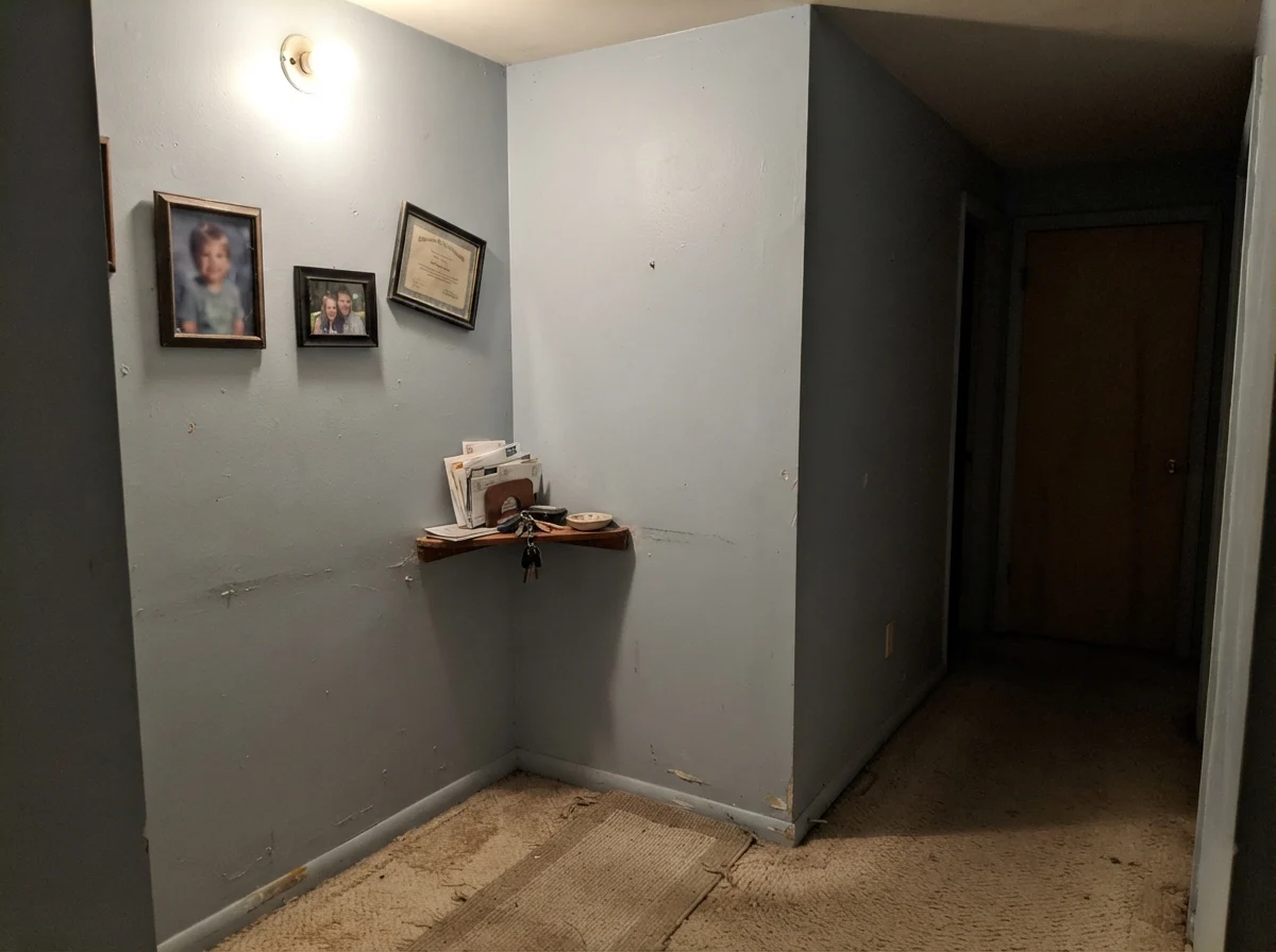 Windowless dim hallway corner showing Upward looking muddy and dull